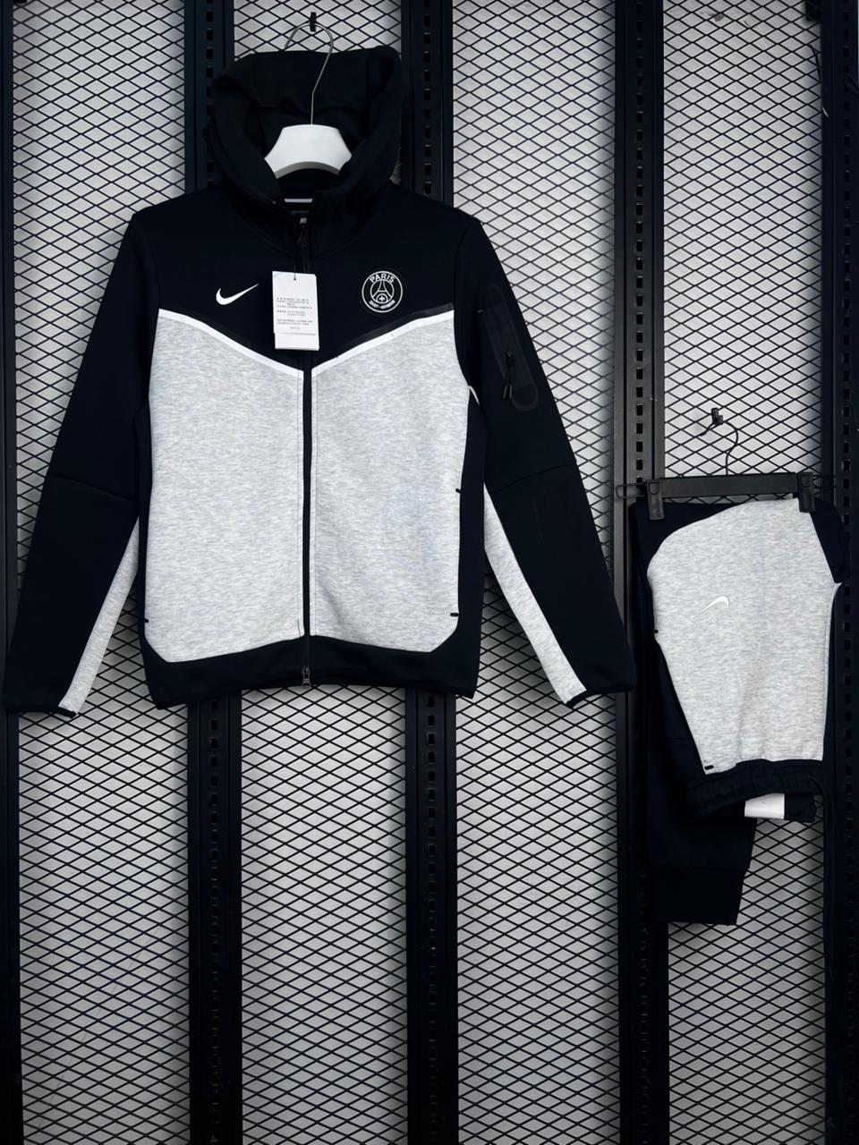 Black and gray hoodie with Nike logo on a grid background